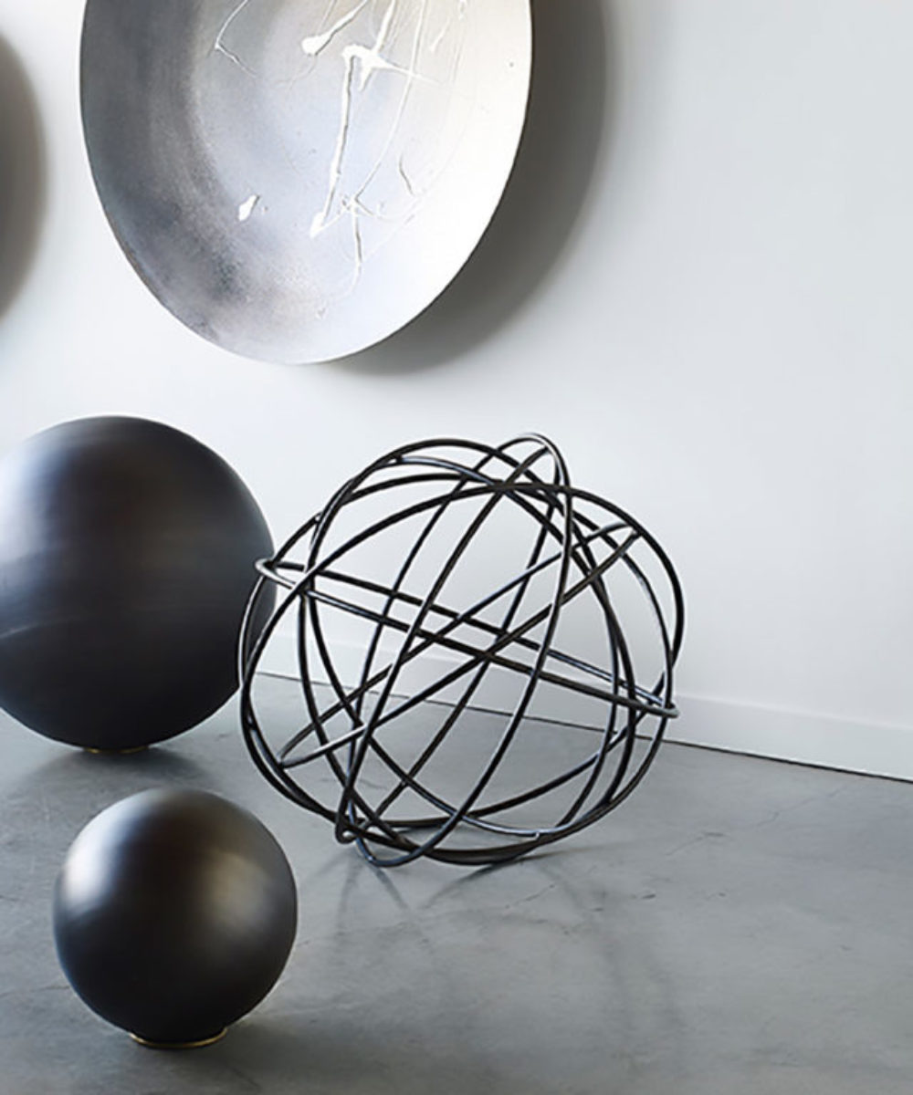 These beautifully crafted large decorative spheres are hand-spun and inspired by the moon. A modern home style decor statement piece for interiors or garden design, the Steel Lunar Spheres, is put together with perfection. Available in rust or steel and comes with a brass ring cradle for easy placement. Available for sale at Studio Sturdy and created by Martha Sturdy