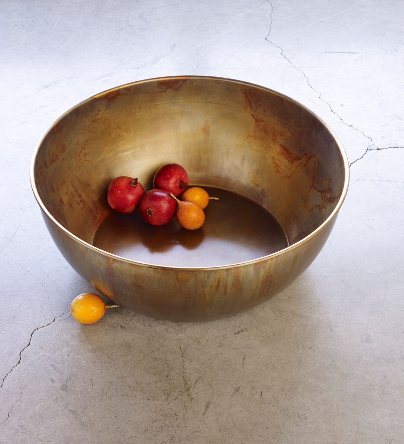 Lovely oversized brass bowls. As featured in New York Spaces. Shown with orange and yellow tomatoes inside. For sale at Studio Sturdy and created by Martha Sturdy